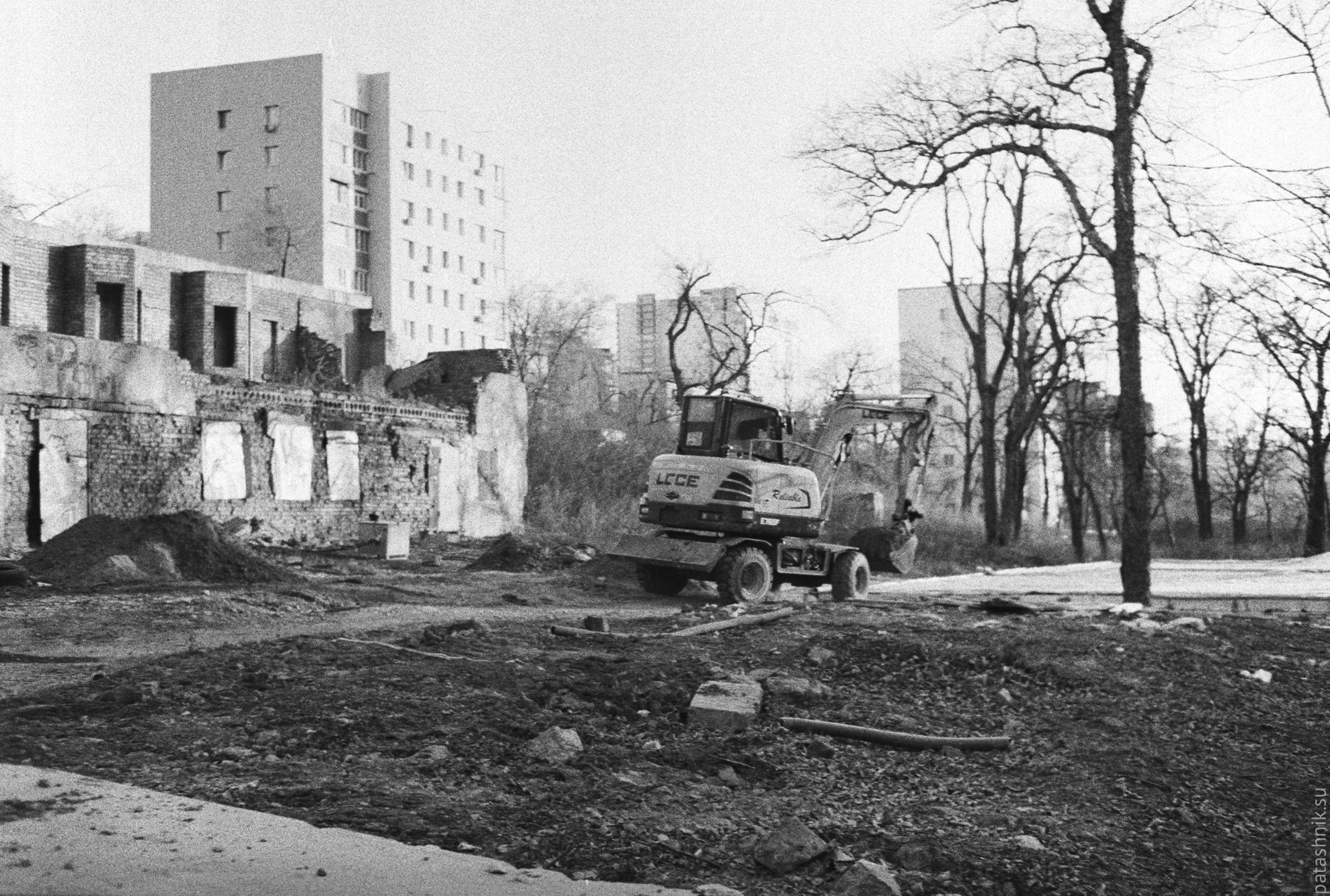 Building site, excavator and ruins